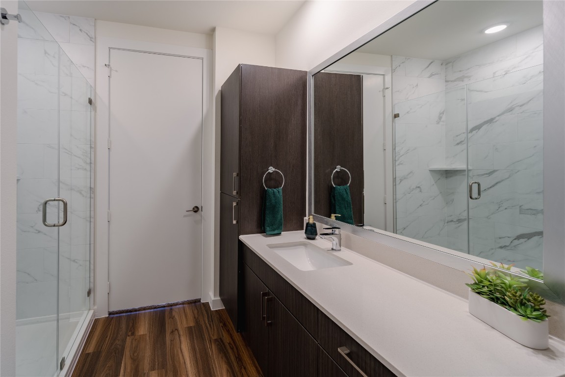 604 East Highland Mall Boulevard, Unit 418314 Austin, TX 78752 - Photo 5 of 10 a bathroom with a sink and a mirror