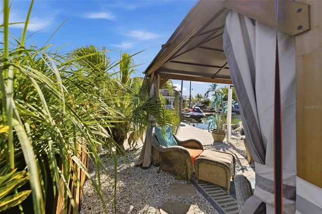 a living room with stainless steel appliances kitchen island granite countertop furniture and a rug