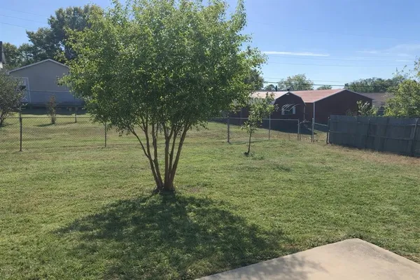 a backyard of a house with lots of green space