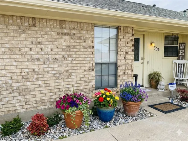 a bunch of flowers in front of house