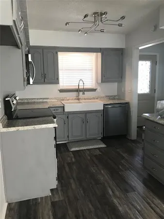 a kitchen with a stove and a sink