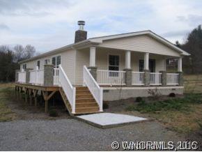259 Ernest Rogers Road Clyde, NC 28721 - Photo 1 of 12 a front view of a house with a yard