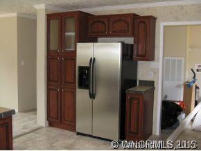 259 Ernest Rogers Road Clyde, NC 28721 - Photo 4 of 12 a metallic refrigerator freezer sitting in a kitchen