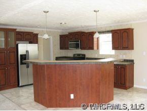 259 Ernest Rogers Road Clyde, NC 28721 - Photo 5 of 12 a kitchen with stainless steel appliances granite countertop a refrigerator and a sink