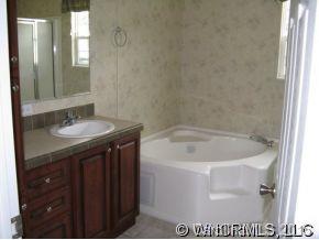 259 Ernest Rogers Road Clyde, NC 28721 - Photo 9 of 12 a bathroom with a sink and a mirror
