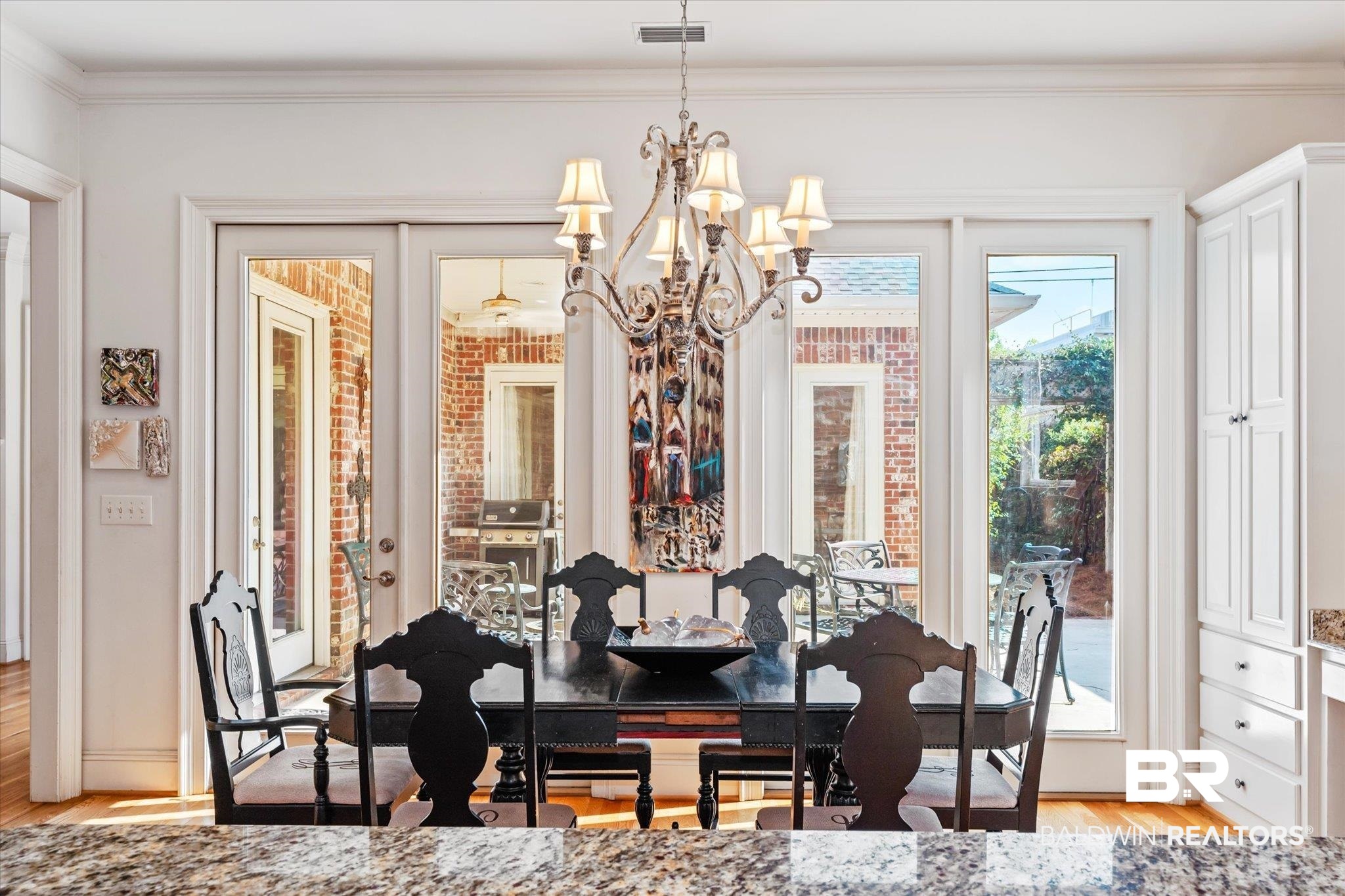 3963 Wimbledon Park Mobile, AL 36608 - Photo 20 of 51 Dining room featuring a wealth of natural light, light wood-type flooring, an inviting chandelier, and crown molding