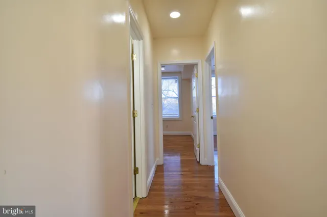 a view of a hallway with a wooden floor