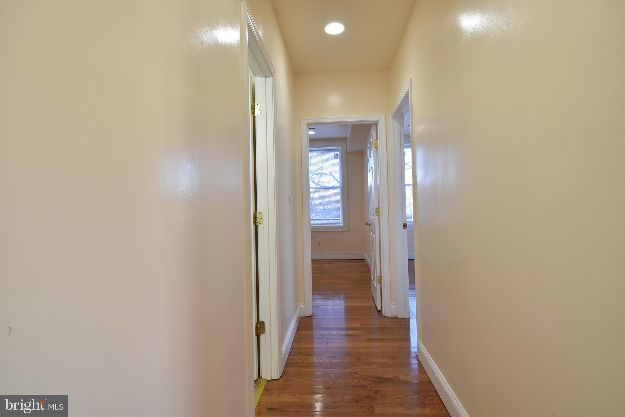 3408 Sherman Avenue Northwest, Unit 202 Washington, DC 20010 - Photo 11 of 20 a view of a hallway with a wooden floor