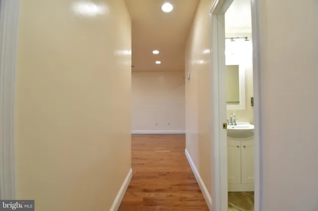 a view of a hallway with wooden floor