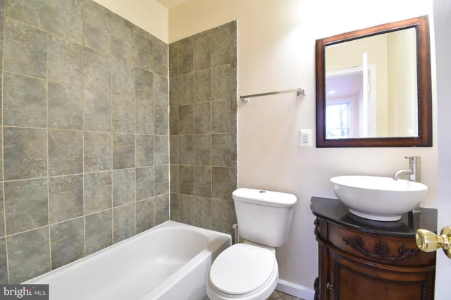 a toilet sitting next to a bathroom sink