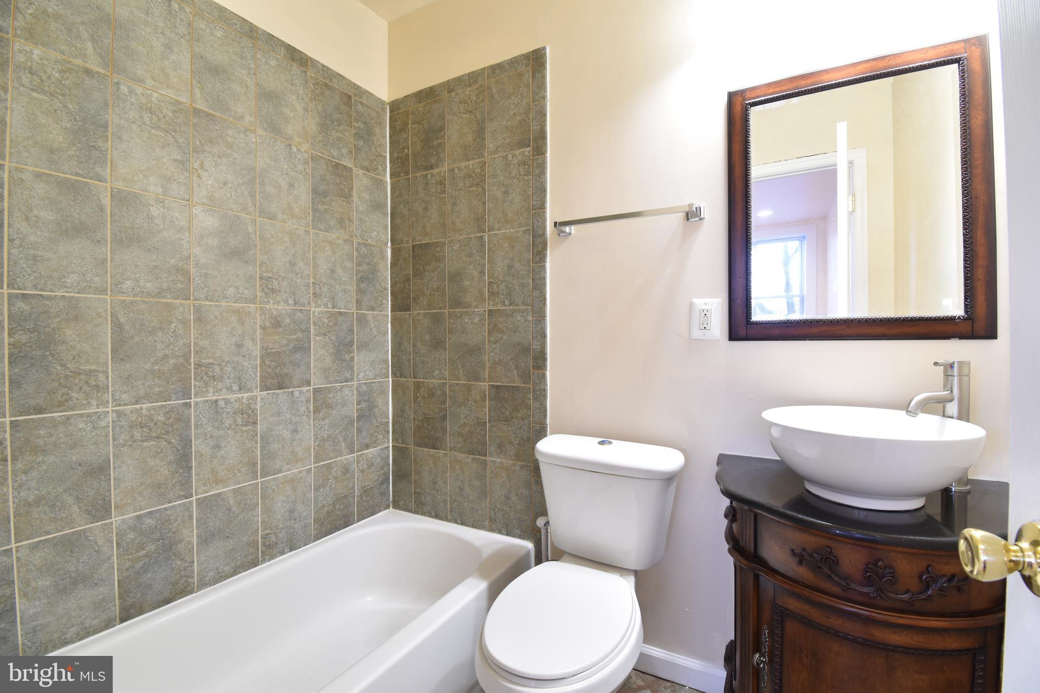 3408 Sherman Avenue Northwest, Unit 202 Washington, DC 20010 - Photo 19 of 20 a toilet sitting next to a bathroom sink