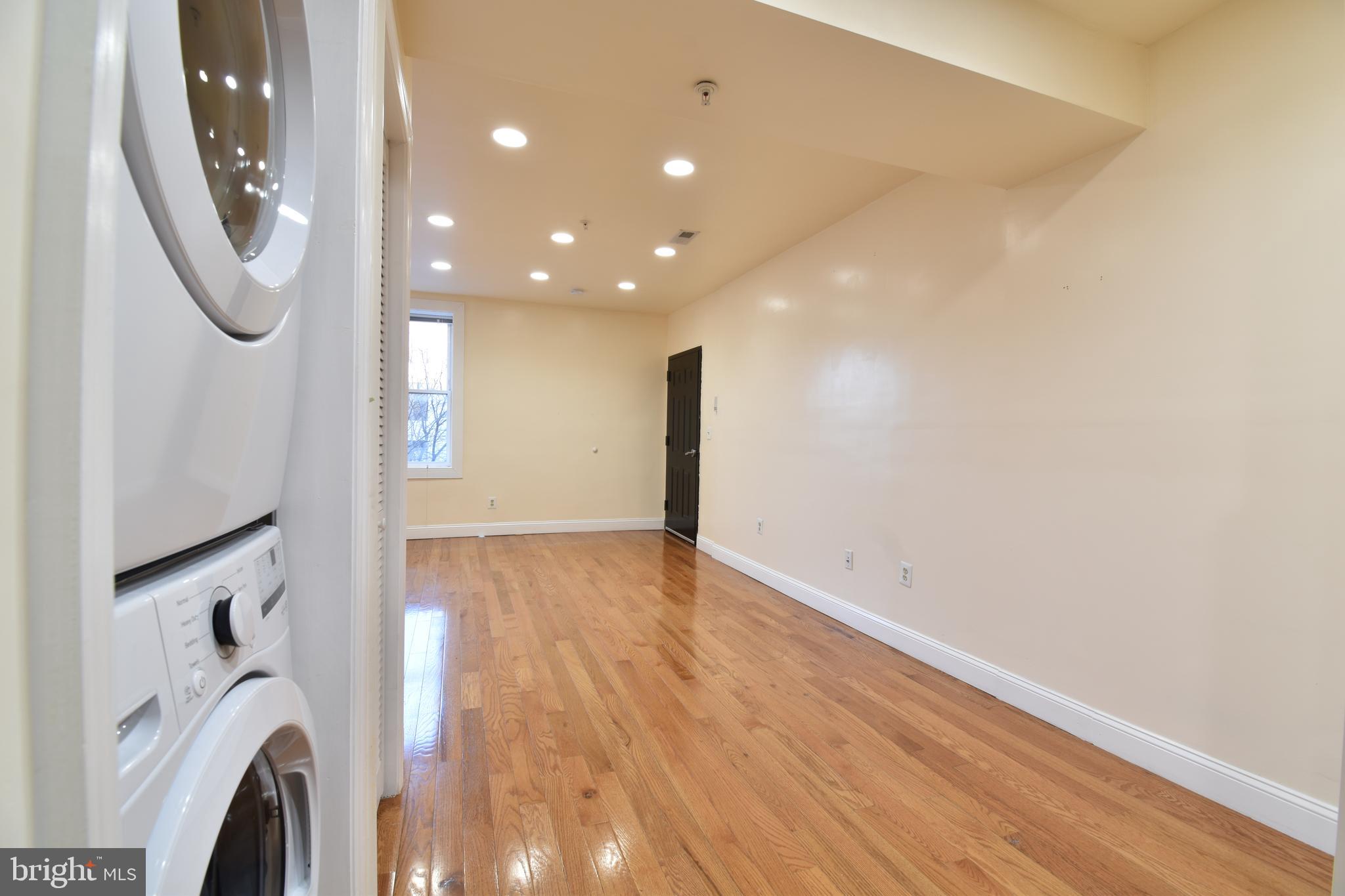 3408 Sherman Avenue Northwest, Unit 202 Washington, DC 20010 - Photo 6 of 20 a view of a hallway with washer and dryer