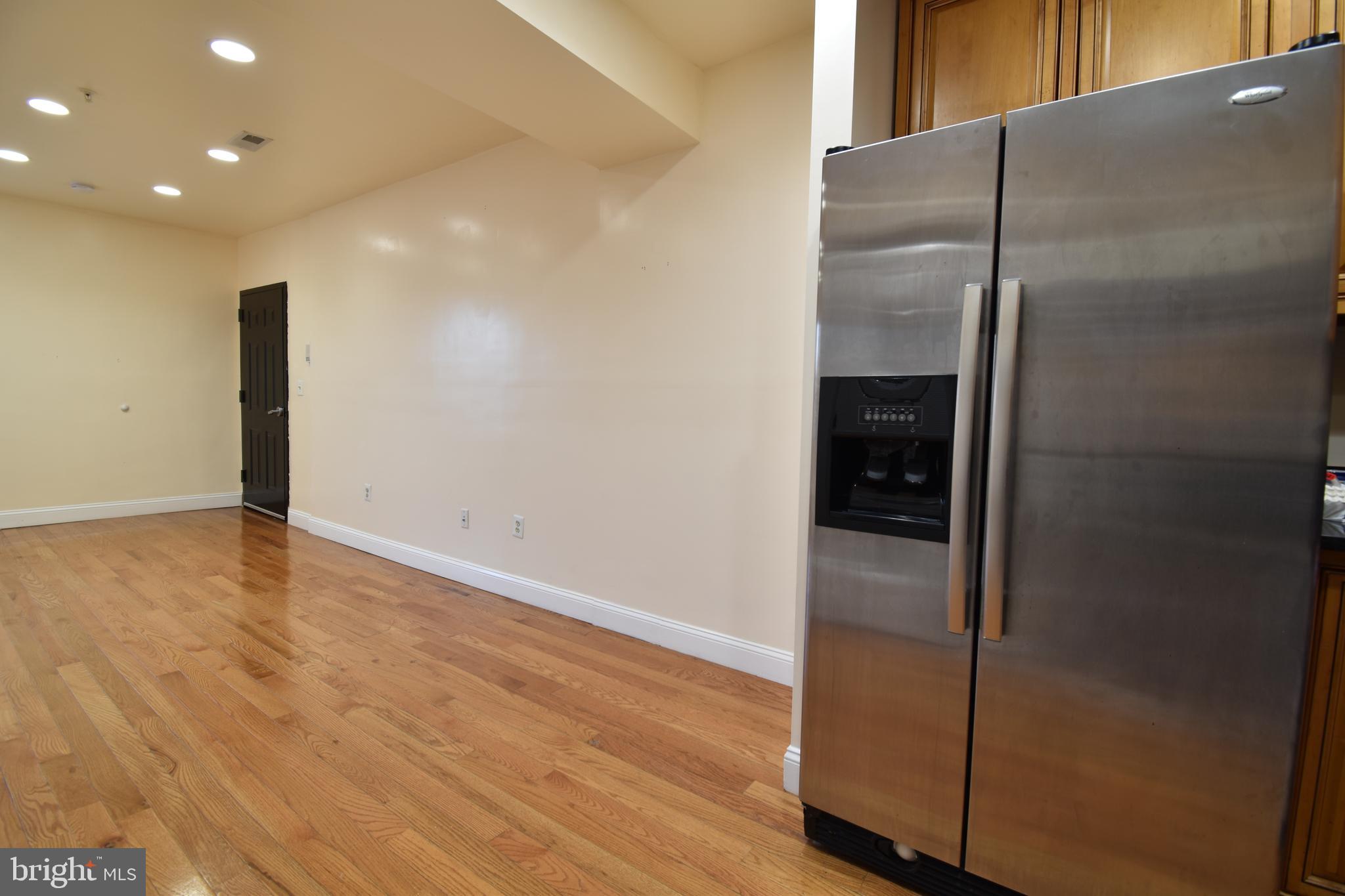 3408 Sherman Avenue Northwest, Unit 202 Washington, DC 20010 - Photo 7 of 20 an empty room with wooden floor