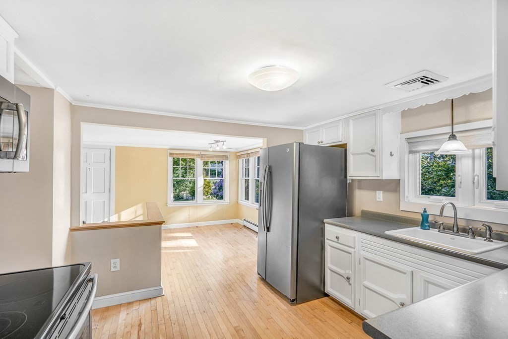 16 Fuller Road Billerica, MA 01821 - Photo 16 of 40 a kitchen with stainless steel appliances granite countertop a refrigerator a sink and wooden floors