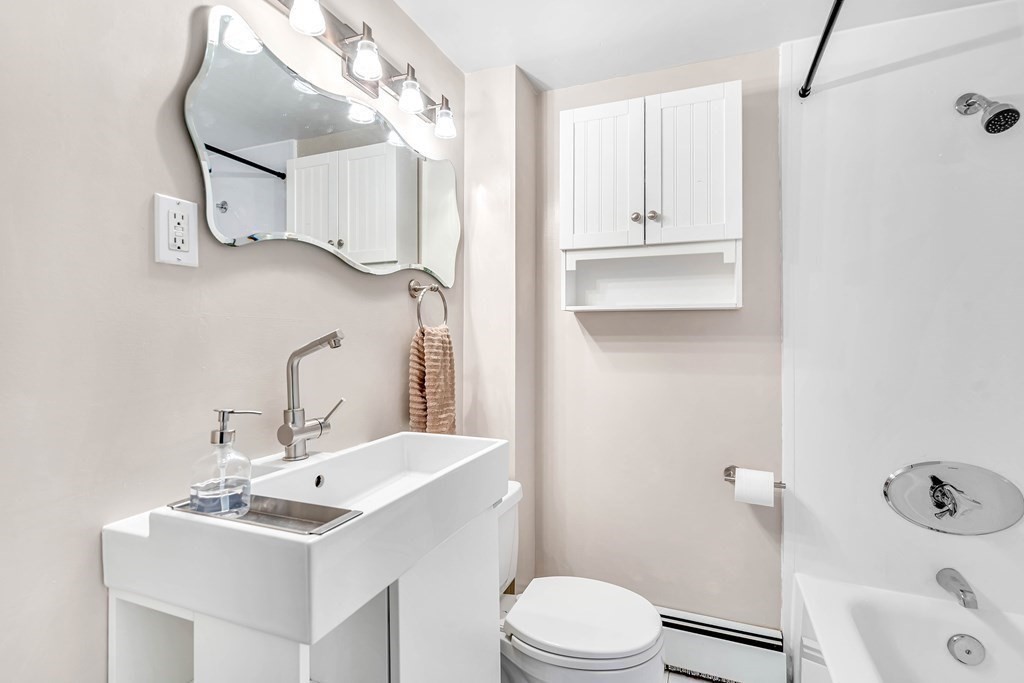 16 Fuller Road Billerica, MA 01821 - Photo 25 of 40 a bathroom with a sink a toilet and shower a mirror