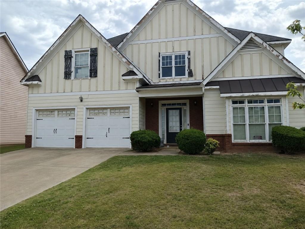 55 Harrison Circle Covington, GA 30016 - Photo 1 of 9 a front view of a house with a yard and garage