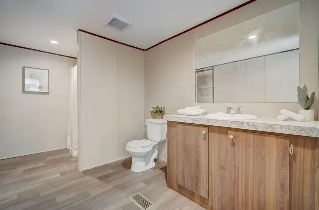 a bedroom with a bed and a potted plant