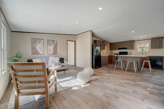 a living room with stainless steel appliances kitchen island granite countertop furniture and a kitchen view