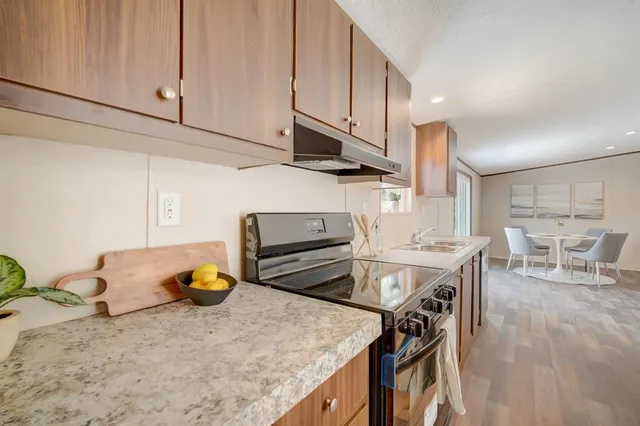 a kitchen with a stove a refrigerator and a sink