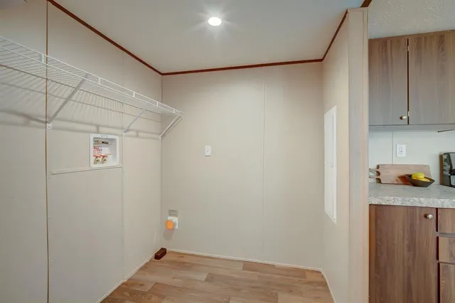 a kitchen with stainless steel appliances granite countertop a stove top oven a sink a dining table and chairs with wooden floor