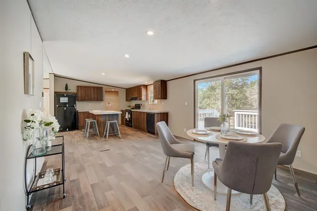 a dining room with furniture and wooden floor