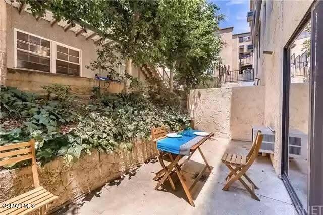 10982 Roebling Avenue, Unit 109 Los Angeles, CA 90024 - Photo 12 of 20 a view of a patio with table and chairs and potted plants