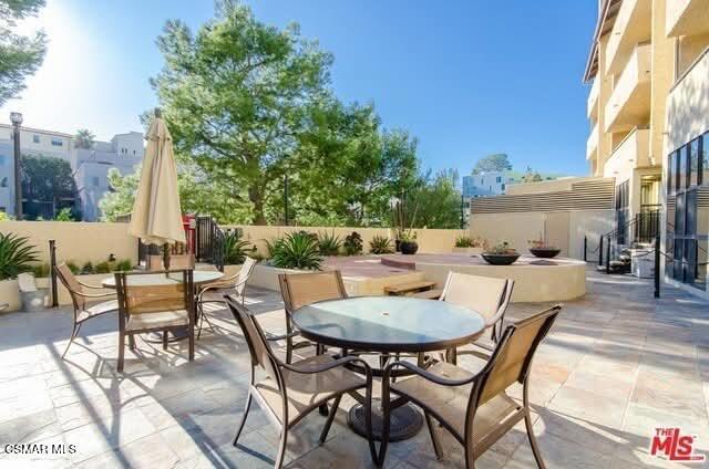 10982 Roebling Avenue, Unit 109 Los Angeles, CA 90024 - Photo 15 of 20 a dining area with furniture and outdoor space