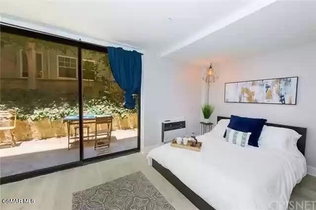 10982 Roebling Avenue, Unit 109 Los Angeles, CA 90024 - Photo 2 of 20 a bedroom with a large bed and a window