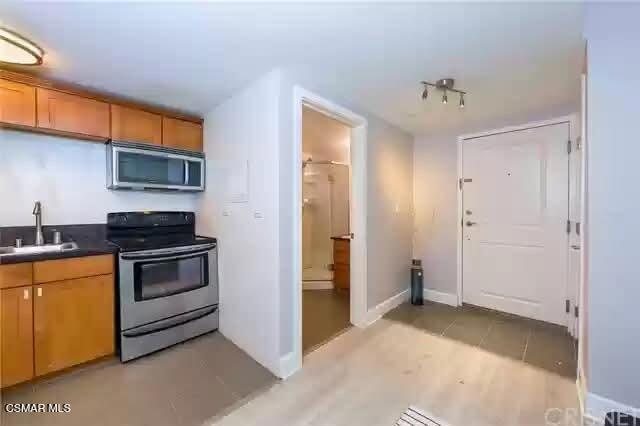 10982 Roebling Avenue, Unit 109 Los Angeles, CA 90024 - Photo 7 of 20 a kitchen with a stove and a cabinet
