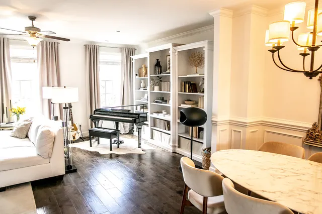 a living room with furniture and wooden floor