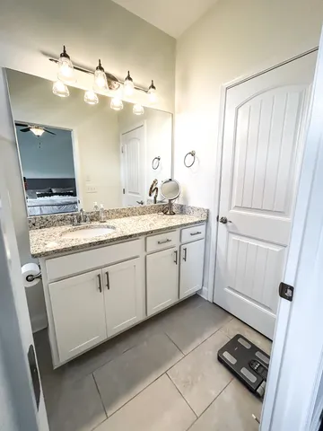 a bathroom with a sink a mirror and a shower
