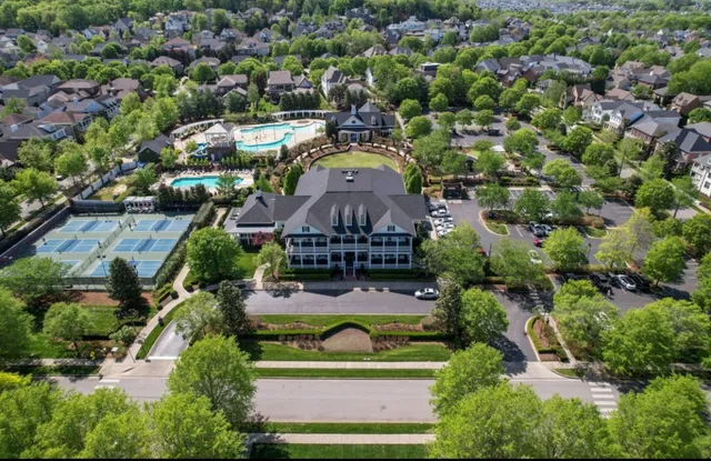 an aerial view of a house with a yard and lake view