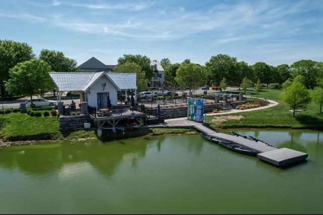 a view of a house with swimming pool and chairs
