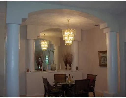 a view of a dining room with furniture and chandelier fan