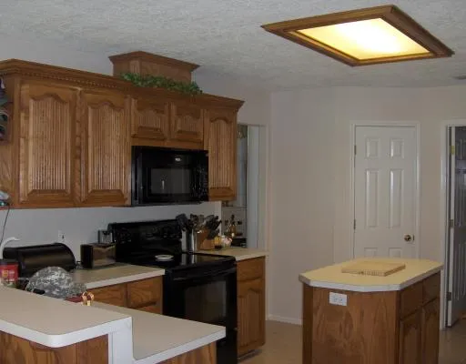 a kitchen with a sink stove and cabinets