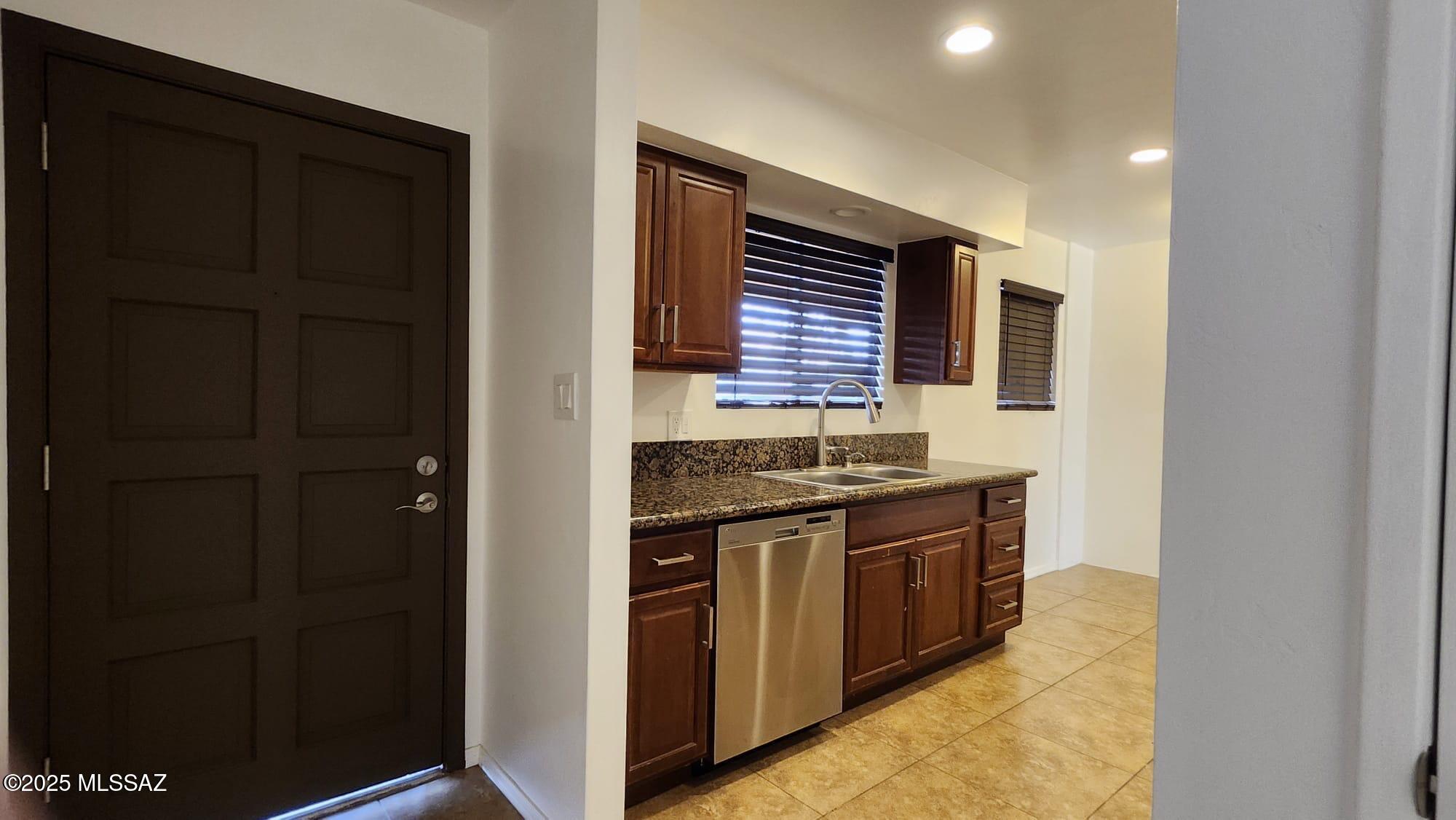1140 Hodges Circle Rio Rico, AZ 85648 - Photo 5 of 24 a kitchen with stainless steel appliances granite countertop a stove and a refrigerator