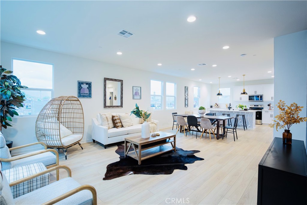 12232 Akira Drive Stanton, CA 90680 - Photo 12 of 39 a living room with furniture gym equipment and a large window