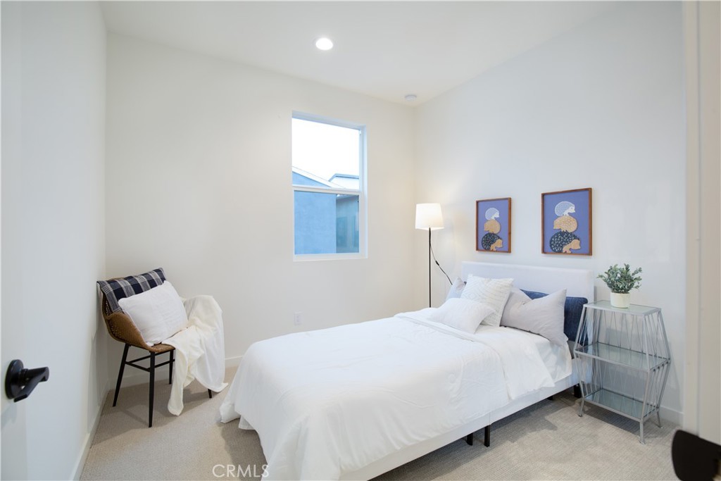 12232 Akira Drive Stanton, CA 90680 - Photo 20 of 39 a bedroom with a bed and a table