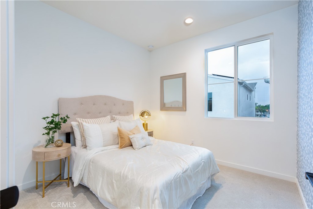 12232 Akira Drive Stanton, CA 90680 - Photo 22 of 39 a bedroom with a bed and a window