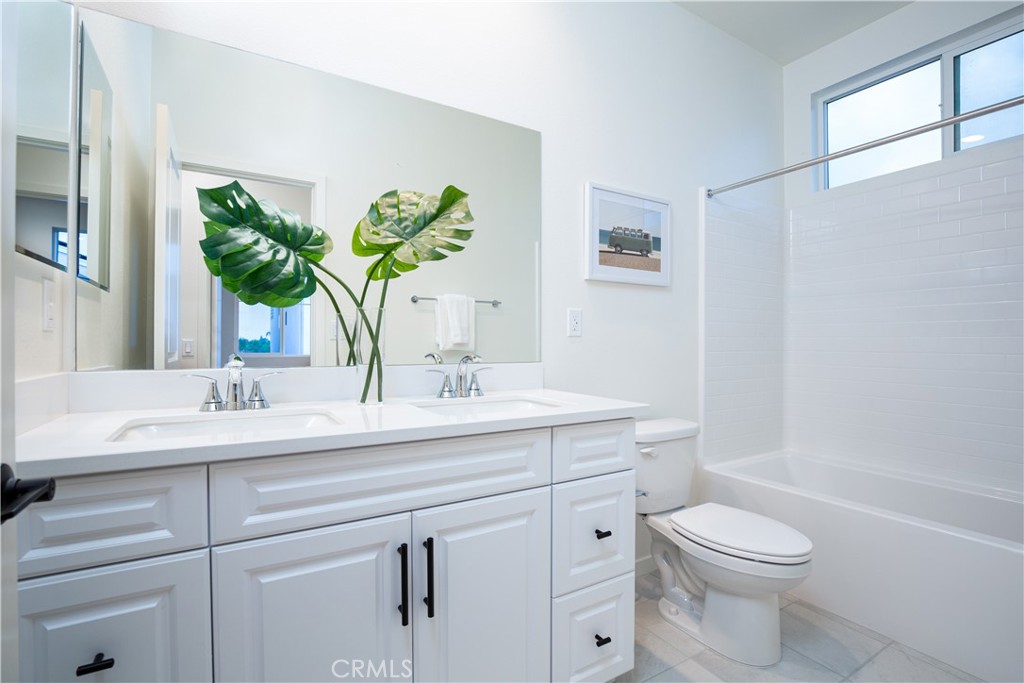 12232 Akira Drive Stanton, CA 90680 - Photo 24 of 39 a bathroom with a granite countertop toilet sink and mirror