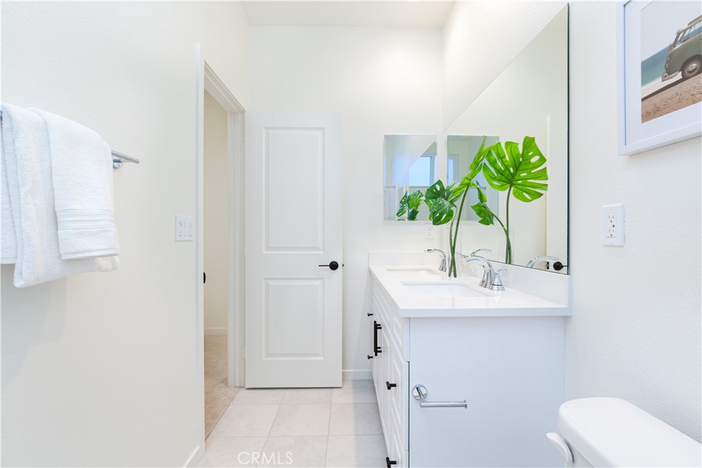 12232 Akira Drive Stanton, CA 90680 - Photo 25 of 39 a bathroom with a sink a toilet and vanity