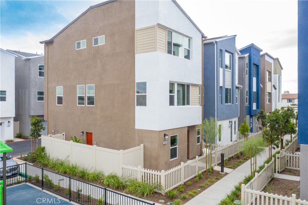 12232 Akira Drive Stanton, CA 90680 - Photo 30 of 39 a view of a white building in front of a yard