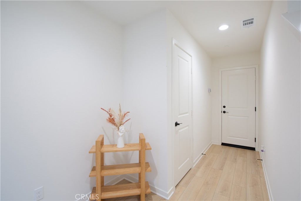12232 Akira Drive Stanton, CA 90680 - Photo 4 of 39 a view of room with stairs and wooden floor