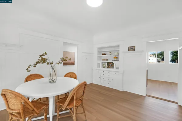 a dining room with furniture and wooden floor