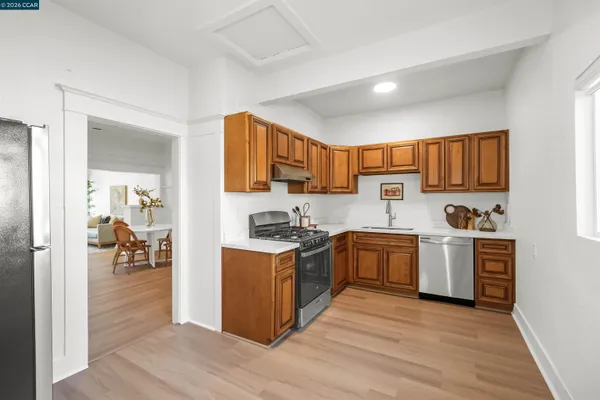 a kitchen with stainless steel appliances granite countertop a stove microwave and refrigerator