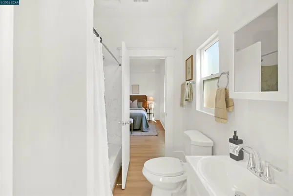a bathroom with a toilet a sink and mirror
