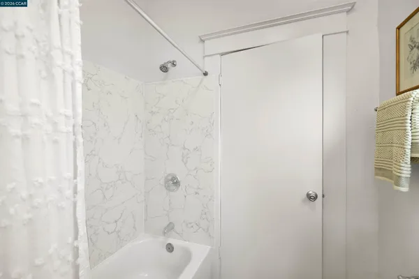 a bedroom with a bed and a chair