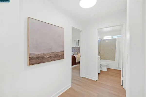 a bedroom with a bed and a painting on the wall