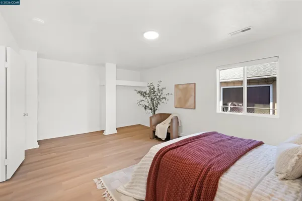 a view of a room with a window and wooden floor