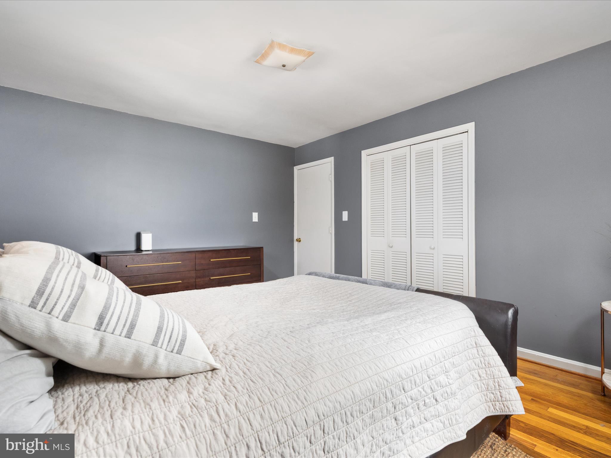 4002 Ronson Drive Alexandria, VA 22310 - Photo 14 of 30 a bedroom with a bed and wooden floor